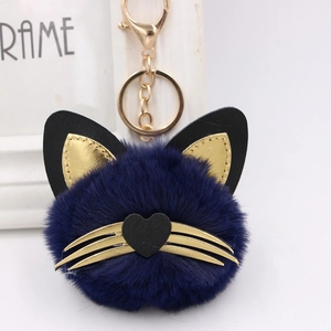 Detailed close-up of dark blue fluffy cat fur keychain with gold lobster clasp
