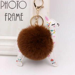 Detail of deer plush keychain with white PU leather floral pattern and brown faux fur pom pom