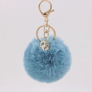 Detailed view of 8cm blue faux rabbit fur keychain with gold crystal geometric pendant