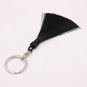 Detailed view of bohemian black silk tassel keychain with polished silver metal ring