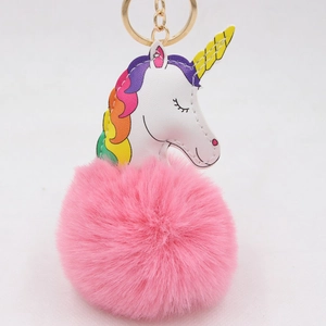Détail du porte-clés licorne en peluche avec boule de fourrure et fermoir en métal doré