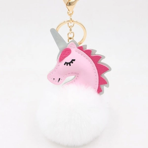 Detail of cute pink unicorn plush pompom keychain with gold-tone lobster clasp