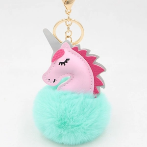 Pink unicorn keychain with mint green faux fur pom pom and golden metal clip attachment
