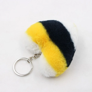 Detail of soft heart-shaped plush keychain with yellow, navy, and white stripes and silver ring