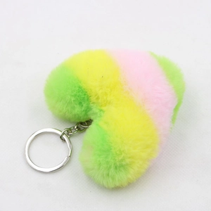 Close-up of heart-shaped plush keychain with colorful striped fur and silver metal ring