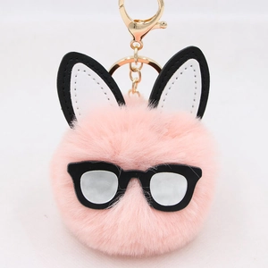 Pink faux fur bunny keychain featuring black glasses and long ears with golden metal clasp
