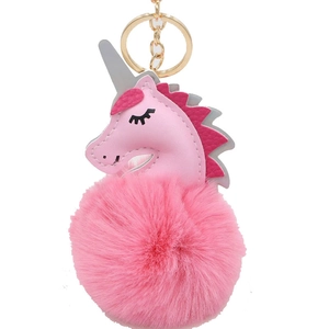 Pink unicorn pom pom keychain accessory with faux leather detail and golden metal ring