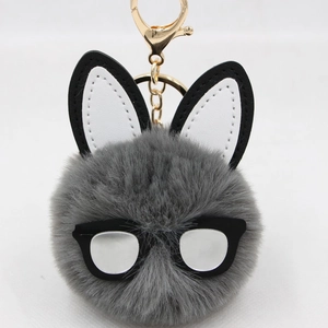 Detail of grey fluffy bunny keychain with black frame glasses and long leather ears