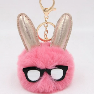 Détail macro du porte-clés lapin en peluche rose avec oreilles pailletées et fermoir doré