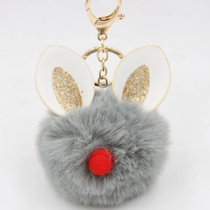 Detail of grey fluffy bunny ear keychain with gold glitter and red pom nose accents
