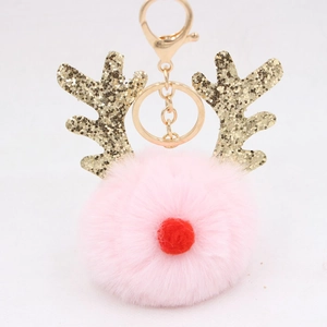 Detail of light pink Christmas reindeer pompom keychain with golden sequined antlers