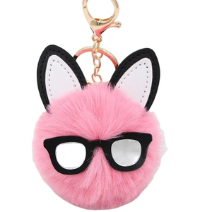 Pink plush rabbit ball keychain with black glasses and long ears on white background