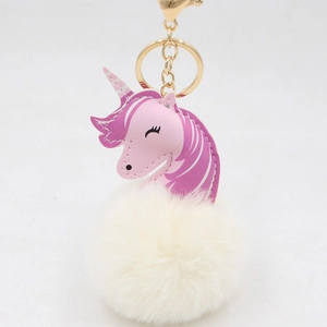 Detail of pink leather unicorn head charm with a large white fluffy faux fur pompom