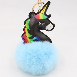 Detail of black PU unicorn keychain featuring rainbow horn and fluffy light blue pompom charm