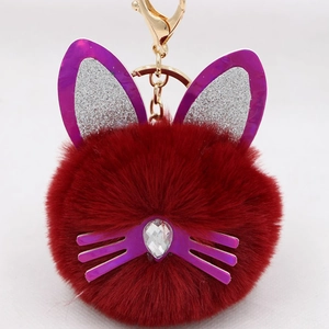 Detail of plush cat ear keychain with purple sequins and a crystal teardrop stone