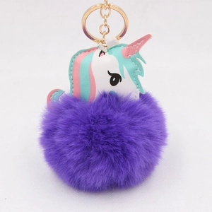 Detailed view of purple unicorn pompom keychain with soft faux fur and gold metal clasp