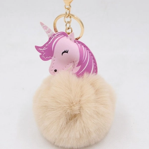 Cute unicorn pompom keychain with pink leather head and soft beige faux fur puff