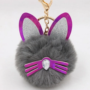 Detailed view of plush cat ear keychain with purple sequins and sparkling teardrop crystal