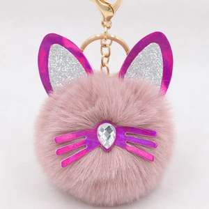 Close-up of pink plush cat keychain with sequined ears and a crystal gemstone detail