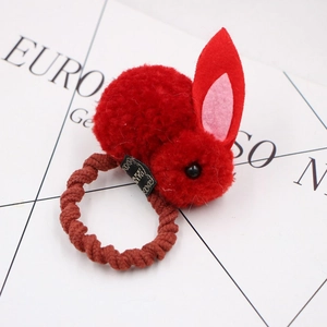 Detail of red plush rabbit hair tie with 3D felt ears and brown spiral elastic band