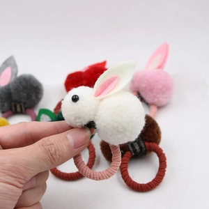 Detail of plush 3D rabbit hair ties in multiple colors with soft elastic texture