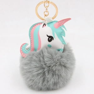 Close-up of unicorn faux fur pompom keychain with creative PU leather patch detail
