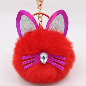 Detail of red plush cat keychain with purple sequin ears and lobster clasp