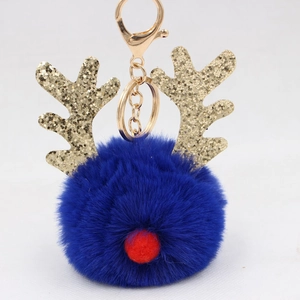 Detail of dark blue plush reindeer pompom keychain with gold glitter antlers and clasp