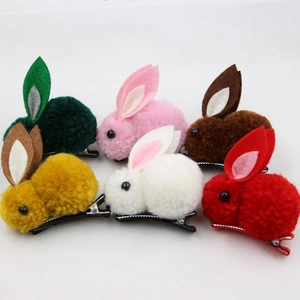 Detail view of colorful plush rabbit hair clips with felt ears and metal duckbill clips