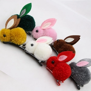 Close-up of colorful plush bunny hair clips set in green, pink, and yellow felt colors