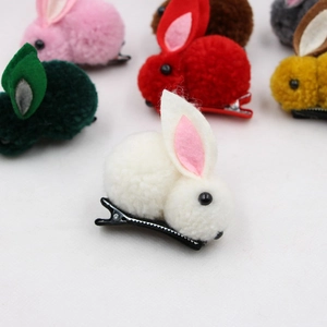 Close-up of colorful plush bunny ear hair clips featuring various soft pastel shades