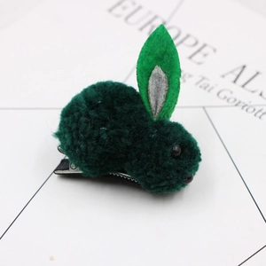 Close-up of a green plush bunny hair clip with felt ears and silver metal duckbill clip