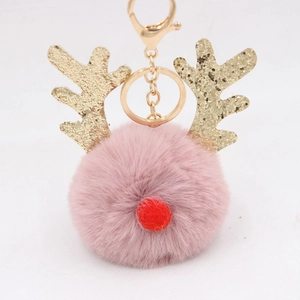 Close-up of pink fluffy pompom reindeer keychain with golden sequin antlers and gold hook