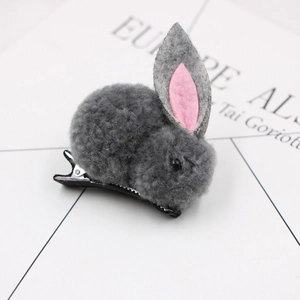 Detailed close-up of gray plush bunny hair clip with soft felt ears and metal alligator grip