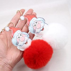 Close-up of Santa Claus plush keychain with faux fur ball and gold metal ring