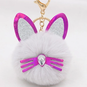 Close-up of cat plush keychain with silver sequin ears and golden lobster clasp