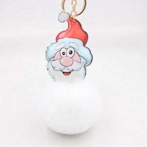 Detailed view of plush Santa Claus keychain with red hat and large white faux fur pompom