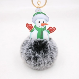 Detail of Christmas snowman keychain with green scarf and soft faux fur pompom ball