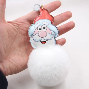 Detail of Santa Claus faux fur pompom keychain with red hat and metal hook