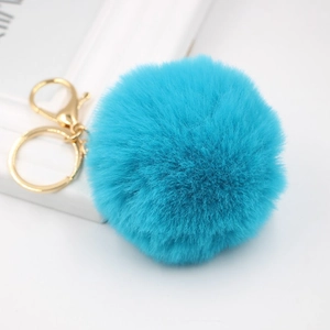 Detail of 8cm turquoise faux rabbit fur pom pom keychain with a golden lobster clasp