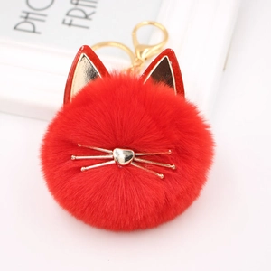 Detail of red plush cat keychain featuring gold hardware and heart-shaped nose accessory