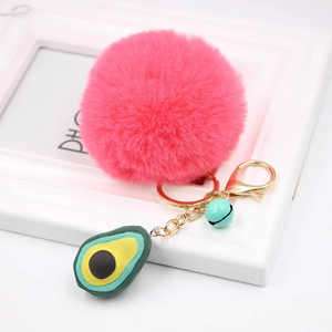 Detail of rose red faux fur pompom keychain with gold lobster clasp and avocado charm