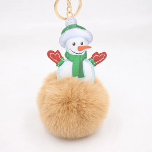 Detailed close-up of Christmas snowman plush keychain with brown faux fur pom pom ball