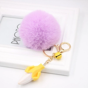 Creative purple plush ball keychain with yellow banana pendant and golden metal bell charm
