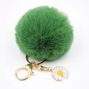 Porte-clés pompon en fourrure verte avec fermoir mousqueton doré et charm marguerite