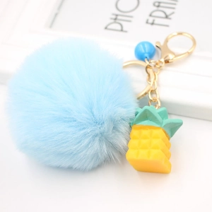 Plush pineapple keychain with light blue faux fur pom pom and gold metal hardware