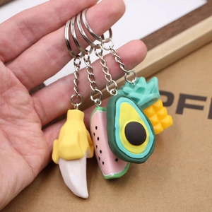 Set of four fruit keychains featuring banana watermelon avocado and pineapple designs