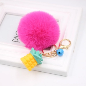 Pink faux fur pompom keychain with yellow pineapple pendant and blue bell for women
