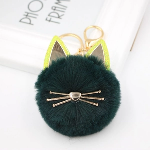 Detailed view of dark green plush cat keychain with sparkling ears and golden whiskers