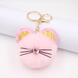Pink plush cat puff keychain with golden ears and heart nose for bags and backpacks